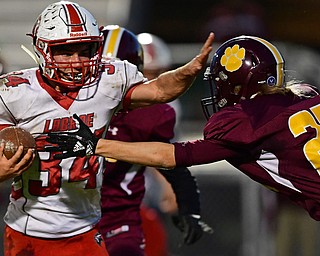 LIBERTY, OHIO - SEPTEMBER 28, 2018: LaBrae's Colton Stoneman fights off a tackle by Liberty's Billy Kocher during the first half of their game, Friday night at Liberty High School. DAVID DERMER | THE VINDICATOR