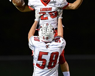 LIBERTY, OHIO - SEPTEMBER 28, 2018: LaBrae's Benton Tennant is lifted by Konner Johnston after scoring a touchdown during the first half of their game, Friday night at Liberty High School. DAVID DERMER | THE VINDICATOR