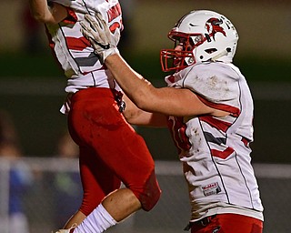 LIBERTY, OHIO - SEPTEMBER 28, 2018: LaBrae's Benton Tennant is lifted by Konner Johnston after scoring a touchdown during the first half of their game, Friday night at Liberty High School. DAVID DERMER | THE VINDICATOR