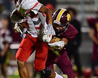 LIBERTY, OHIO - SEPTEMBER 28, 2018: LaBrae's Walton Allie runs while attempting to fight off Liberty's Kameron Thomas during the first half of their game, Friday night at Liberty High School. DAVID DERMER | THE VINDICATOR