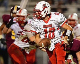 LIBERTY, OHIO - SEPTEMBER 28, 2018: LaBrae's Kent Wolford rolls out to pass during the first half of their game, Friday night at Liberty High School. DAVID DERMER | THE VINDICATOR