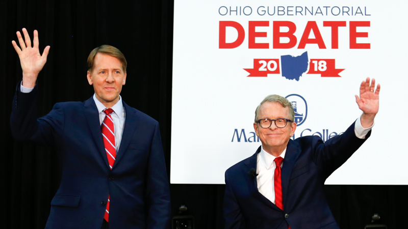 Democratic gubernatorial candidate Richard Cordray, left, and Mike DeWine, the Republican candidate, prepare to give remarks at their second debate Monday at Marietta College in Marietta.