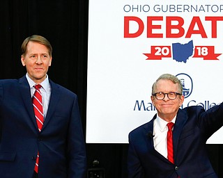 Democratic gubernatorial candidate Richard Cordray, left, and Mike DeWine, the Republican candidate, prepare to give remarks at their second debate Monday at Marietta College in Marietta.