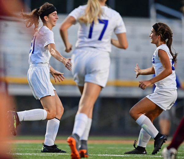 NORTH LIMA, OHIO - OCTOBER 1, 2018: Poland's Jackie Grisdale, left, is congratulated by Mia Marantis after scoring a goal during the first half of their game, Monday night at South Range High School. DAVID DERMER | THE VINDICATOR