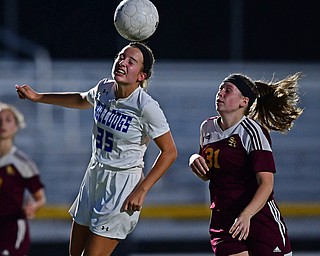 NORTH LIMA, OHIO - OCTOBER 1, 2018: Poland's Molly Malmer heads the ball away from South Range's Hannah Ritchie during the first half of their game, Monday night at South Range High School. DAVID DERMER | THE VINDICATOR