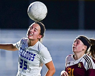Molly Malmer of Poland Seminary High School heads the ball away from Hannah Ritchie of South Range High Scool during the first half of their soccer game Monday. Poland blanked South Range 5-0.