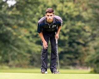 DIANNA OATRIDGE | THE VINDICATOR  Poland's Jake Snyder eyes his putt on Hole No. 4 during play at the Division II District Tournament at Windmill Lakes Golf Course in Ravenna on Tuesday.