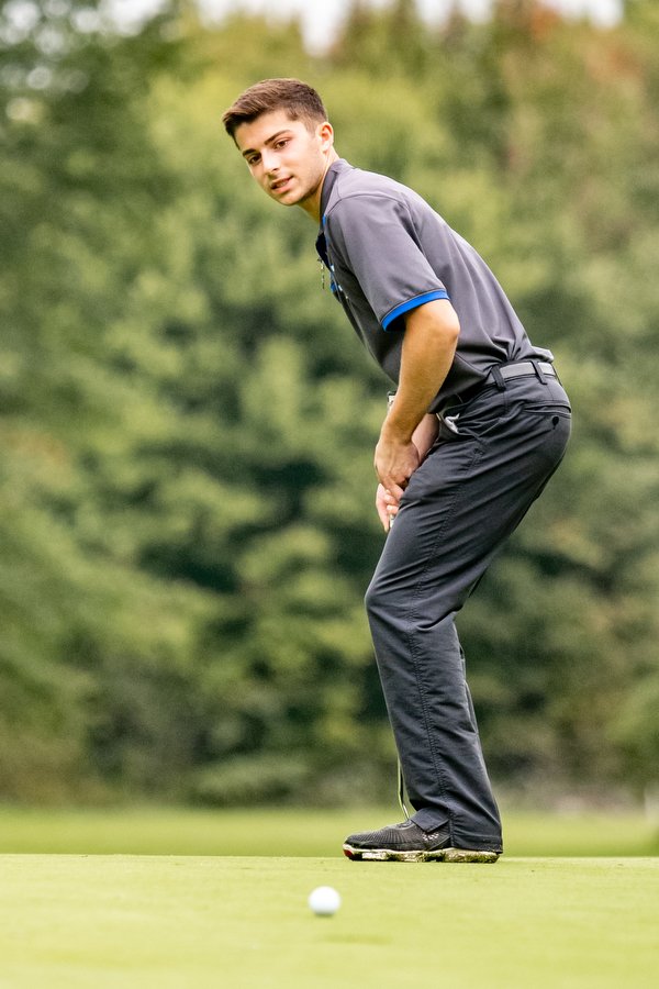 DIANNA OATRIDGE | THE VINDICATOR  Poland's Jake Snyder coaxes the ball into the cup after his putt on Hole No. 4 during the Division II District Tournament at Windmill Lakes Golf Course in Ravenna on Tuesday.