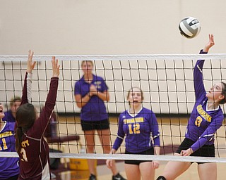 Champion's Maggie Dunlap hits the ball over the net during their game at Liberty on Wednesday. EMILY MATTHEWS | THE VINDICATOR