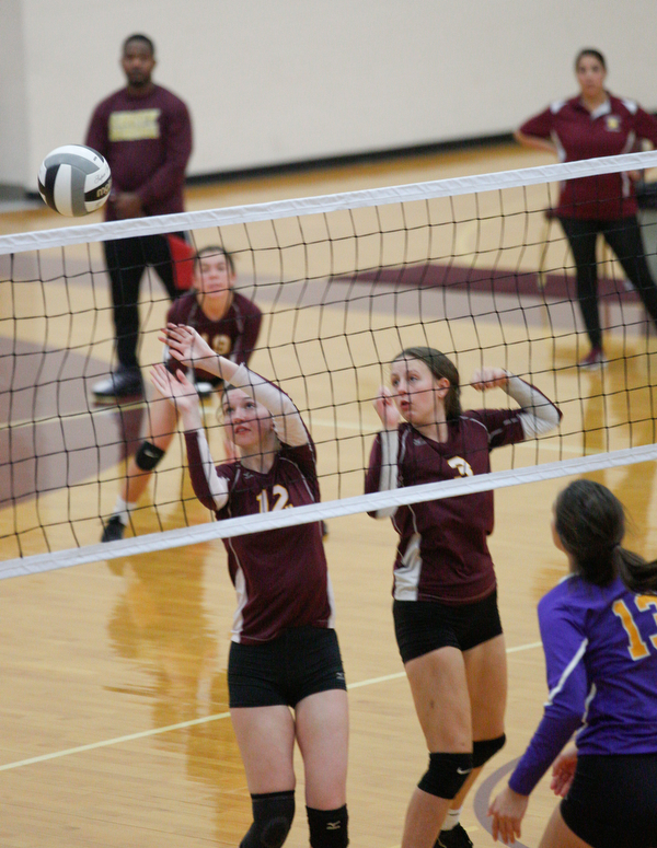 Liberty's Erica Carnes (12) and Allyson Jones (3) watch the ball go over the net from Champion's side during their game at Liberty on Wednesday. EMILY MATTHEWS | THE VINDICATOR