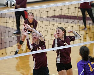 Liberty's Erica Carnes (12) and Allyson Jones (3) watch the ball go over the net from Champion's side during their game at Liberty on Wednesday. EMILY MATTHEWS | THE VINDICATOR