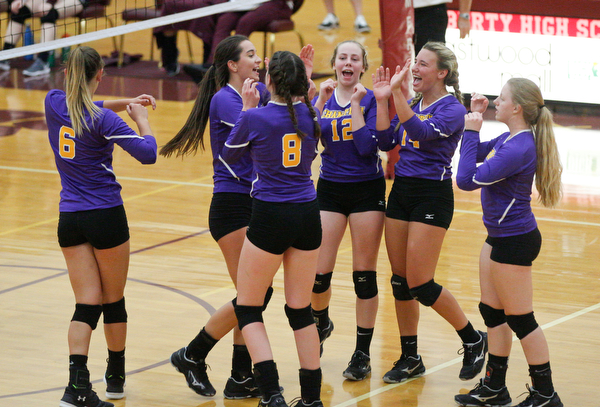 Champion's team celebrates after scoring a point against Liberty during their game at Liberty on Wednesday. EMILY MATTHEWS | THE VINDICATOR