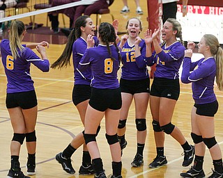 Champion's team celebrates after scoring a point against Liberty during their game at Liberty on Wednesday. EMILY MATTHEWS | THE VINDICATOR