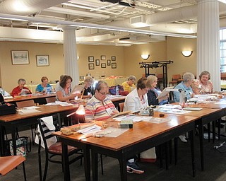 Neighbors | Jessica Harker.Participants in the Youngstown Embroiderers' Guild's Ohio State Day worked on a counted canvas piece on Sept. 14 at the Poland library.