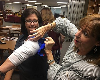 Neighbors | Submitted.School nurse Loraine Cullen is pictured having a tourniquet tightened on her arm during the Stop the Bleed training at Boardman high school on Sept. 19.