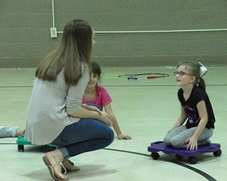 Neighbors | Jessica Harker.Senior student at Poland Seminary High School Hannah Balash spoke with two second-graders during their free time in gym Sept. 26 during the Big Dog Little Dog mentorship program.