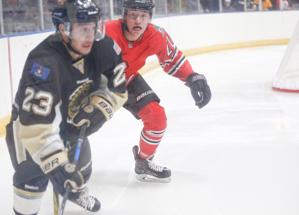 Youngstown's John Larkin tries to get the puck from Muskegon's Brock Bremer during their game at Covelli Centre on Friday night. EMILY MATTHEWS | THE VINDICATOR