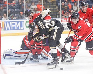 Youngstown's Joey Abate gets the puck away from the net as he takes it from Muskegon's Jagger Joshua during their game at Covelli Centre on Friday night. EMILY MATTHEWS | THE VINDICATOR