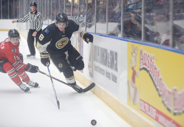 Muskegon's Nash Nienhuis and Youngstown's Ben Schoen go after the puck during their game at Covelli Centre on Friday night. EMILY MATTHEWS | THE VINDICATOR