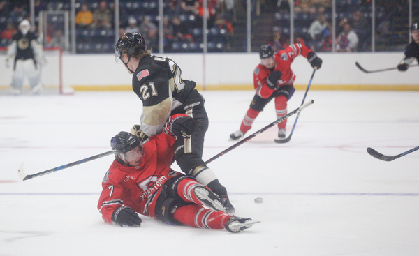 Youngstown's Tristan Amonte falls as the puck gets away from him and Muskegon's Christoffer Bjork during their game at Covelli Centre on Friday night. EMILY MATTHEWS | THE VINDICATOR