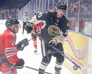 Youngstown's John Larkin and Muskegon's Christoffer Bjork go after the puck during their game at Covelli Centre on Friday night. EMILY MATTHEWS | THE VINDICATOR