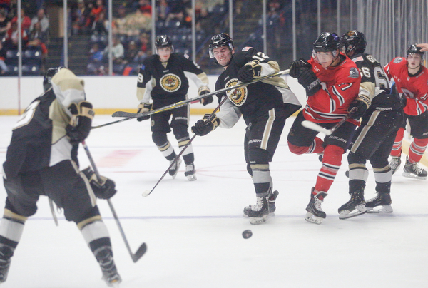 Youngstown's John Larkin tries to get away from Muskegon to get to the puck during their game at Covelli Centre on Friday night. EMILY MATTHEWS | THE VINDICATOR