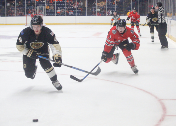 Muskegon's Nic Belpedio and Youngstown's Roman Kraemer go after the puck during their game at Covelli Centre on Friday night. EMILY MATTHEWS | THE VINDICATOR