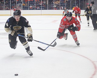 Muskegon's Nic Belpedio and Youngstown's Roman Kraemer go after the puck during their game at Covelli Centre on Friday night. EMILY MATTHEWS | THE VINDICATOR