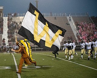 DIANNA OATRIDGE | THE VINDICATOR  The Warren Harding Raider mascot leads the team on to the field before their game against Boardman at Spartan Stadium on Friday.