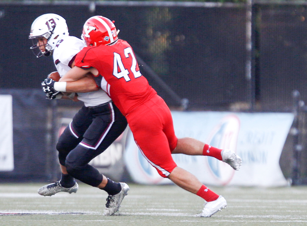 YSU's Armand Dellovade tackles Southern Illinois's Nigel Kilby during the first half of their game at Stambaugh Stadium on Saturday. EMILY MATTHEWS | THE VINDICATOR