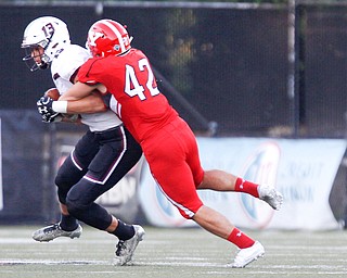 YSU's Armand Dellovade tackles Southern Illinois's Nigel Kilby during the first half of their game at Stambaugh Stadium on Saturday. EMILY MATTHEWS | THE VINDICATOR