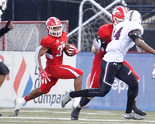 YSU's Tevin McCaster tries to stay away from Southern Illinois as he runs with the ball during the first half of their game at Stambaugh Stadium on Saturday. EMILY MATTHEWS | THE VINDICATOR