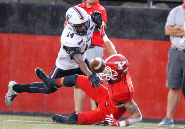 Southern Illinois's Torian Lewis tackles YSU's Darius Shackleford to prevent his from catching the ball during the first half of their game at Stambaugh Stadium on Saturday. EMILY MATTHEWS | THE VINDICATOR