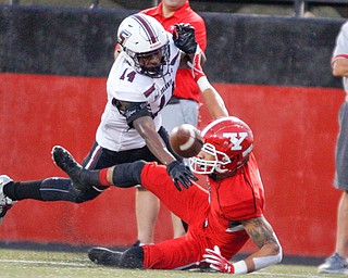 Southern Illinois's Torian Lewis tackles YSU's Darius Shackleford to prevent his from catching the ball during the first half of their game at Stambaugh Stadium on Saturday. EMILY MATTHEWS | THE VINDICATOR