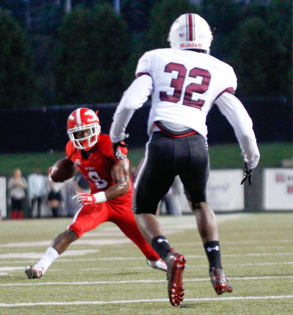 YSU's Samuel St. Surin tries to get past Southern Illinois's Joe Patterson during the first half of their game at Stambaugh Stadium on Saturday. EMILY MATTHEWS | THE VINDICATOR