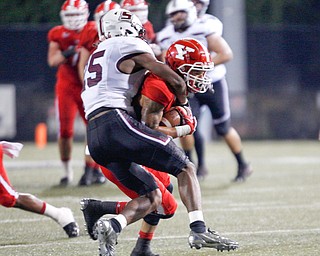 Southern Illinois's Madre Harper starts to tackle YSU's Darius Shackleford during the first half of their game at Stambaugh Stadium on Saturday. EMILY MATTHEWS | THE VINDICATOR