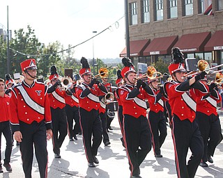 The YSU marching band marches in in the YSU homecoming parade while dressed as penguins on Saturday. EMILY MATTHEWS | THE VINDICATOR