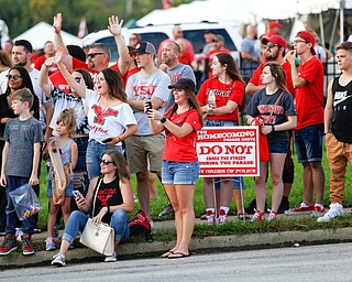 People watching the parade wave at those marching in the YSU homecoming parade on Saturday. EMILY MATTHEWS | THE VINDICATOR