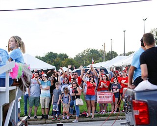 People watching the parade wave at those marching in the YSU homecoming parade on Saturday. EMILY MATTHEWS | THE VINDICATOR