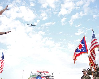 A plane flies overhead while the YSU alumni band performs before the game on Saturday. EMILY MATTHEWS | THE VINDICATOR