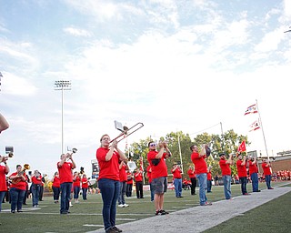 A plane flies overhead while the YSU alumni band performs before the game on Saturday. EMILY MATTHEWS | THE VINDICATOR