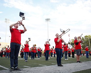 The YSU alumni band perform and watch as a plane flies overhead before the start of the homecoming football game on Saturday. EMILY MATTHEWS | THE VINDICATOR