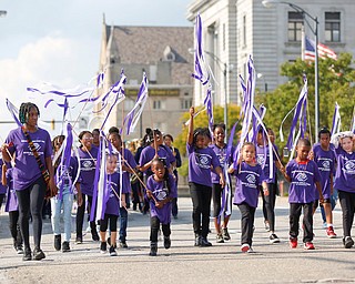 Members of the Boys and Girls Club of Youngstown march down Front Street during the Nonviolence Week parade on Sunday afternoon.  EMILY MATTHEWS | THE VINDICATOR