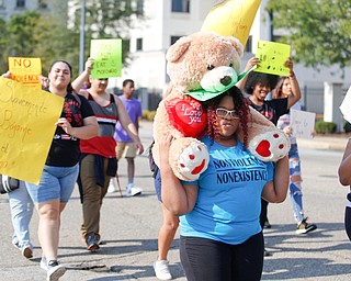 Rashawna Watson, 15, of Youngstown, carries a bear with a sign the says "My Life Matters" as she marches with her family and others in the Nonviolence Week parade on Sunday afternoon. Watson said she and her family participate in the parade every year. EMILY MATTHEWS | THE VINDICATOR