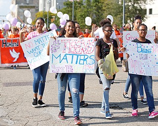 Participants in the Nonviolence Week parade march down Front Street on Sunday afternoon. The parade was the kickoff for Nonviolence week in Youngstown. EMILY MATTHEWS | THE VINDICATOR