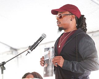 City Councilman Julius Oliver speaks about nonviolence and holds up a copy of Valley Business Magazine that he was on the cover of at the Nonviolence Week Rally outside of Covelli Centre on Sunday afternoon. EMILY MATTHEWS | THE VINDICATOR