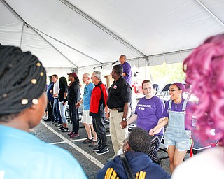 People hold hands while singing "This Little Light of Mine" led by Minnijean Brown Trickey, one of the Little Rock Nine, at the Nonviolence Week Rally outside of Covelli Centre on Sunday afternoon. EMILY MATTHEWS | THE VINDICATOR