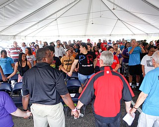 People hold hands while singing "This Little Light of Mine" led by Minnijean Brown Trickey, one of the Little Rock Nine, at the Nonviolence Week Rally outside of Covelli Centre on Sunday afternoon. EMILY MATTHEWS | THE VINDICATOR