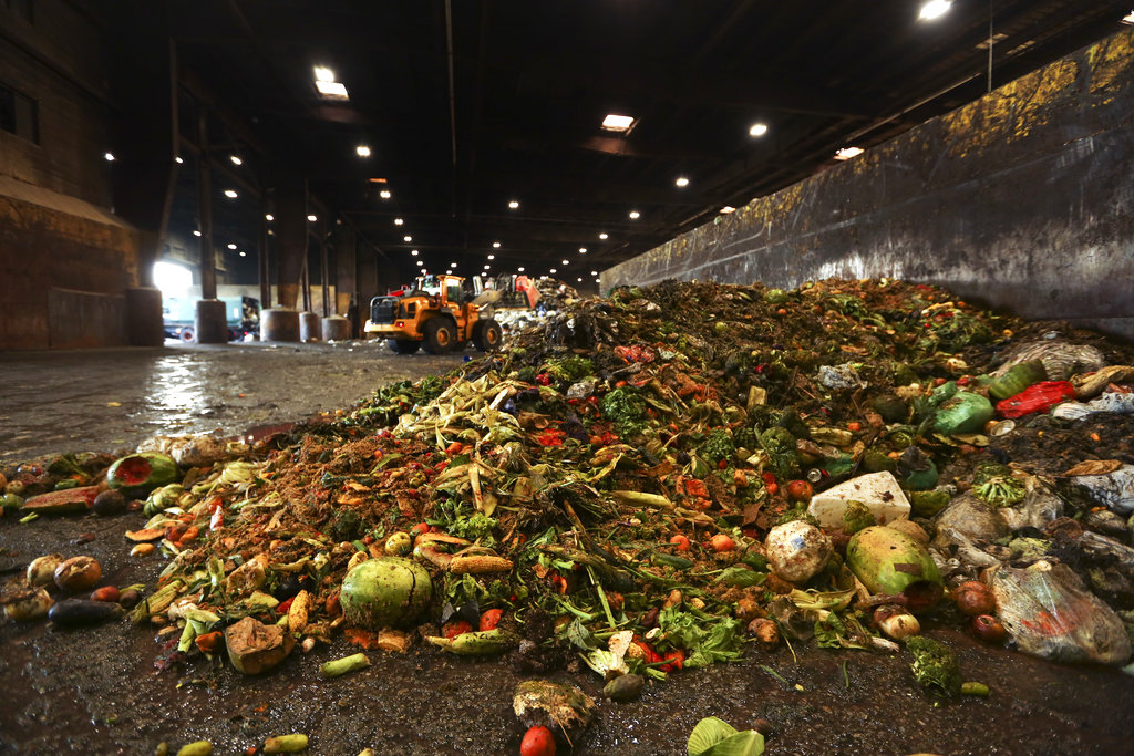 In this Aug. 29, 2018, photo, at the Waste Management facility in North Brooklyn, tons of leftover food sits piled up before being processed into "bio-slurry," in New York. The "bio-slurry" can be turned into methane gas at a nearby waste-treatment plant.