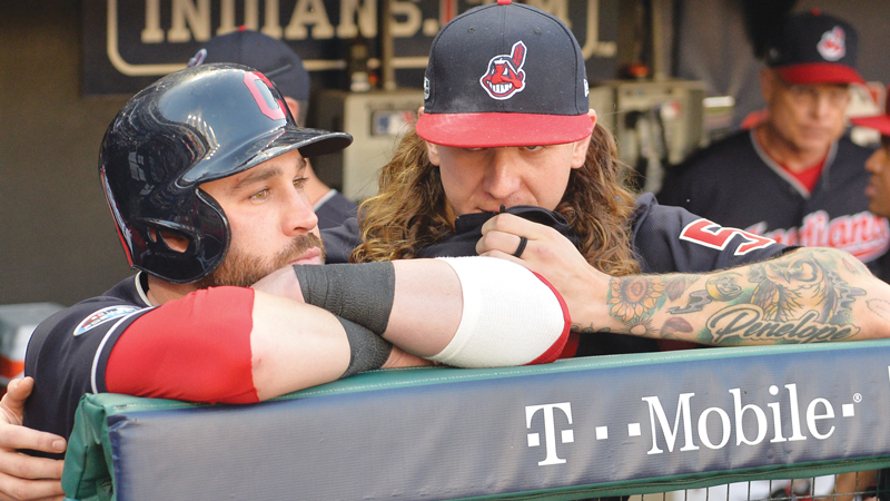 Cleveland Indians' Jason Kipnis, left, is hugged by starting pitcher Mike Clevinger after the Houston Astros defeated the Indians 11-3 in Game 3 of a baseball American League Division Series Monday in Cleveland.